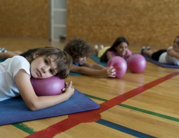 medium-shot-kids-laying-yoga-mats
